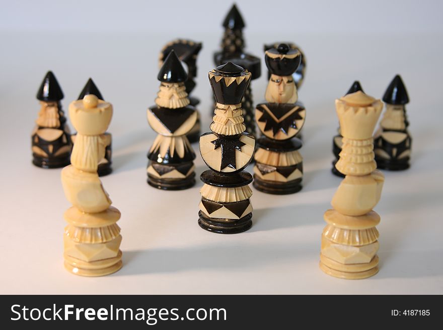 White and black chess-men are staying together and discussing questions.