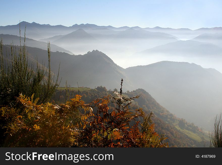 Fog between mountains in background. Fog between mountains in background