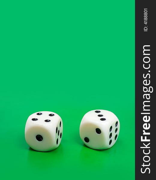 Two gambling dices on green background