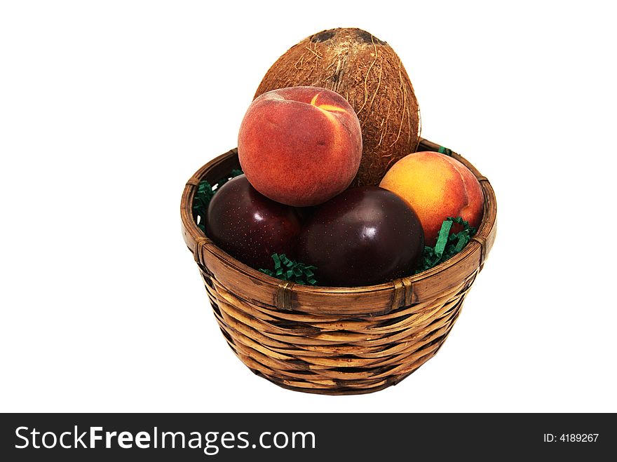 A fruit basket containing plums, peaches and a coconut. A fruit basket containing plums, peaches and a coconut.