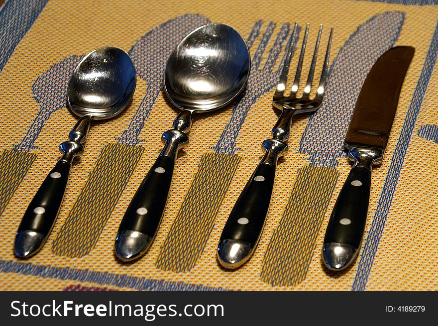 Swedish table linen serves as a backdrop for a cutlery grouping. Swedish table linen serves as a backdrop for a cutlery grouping.