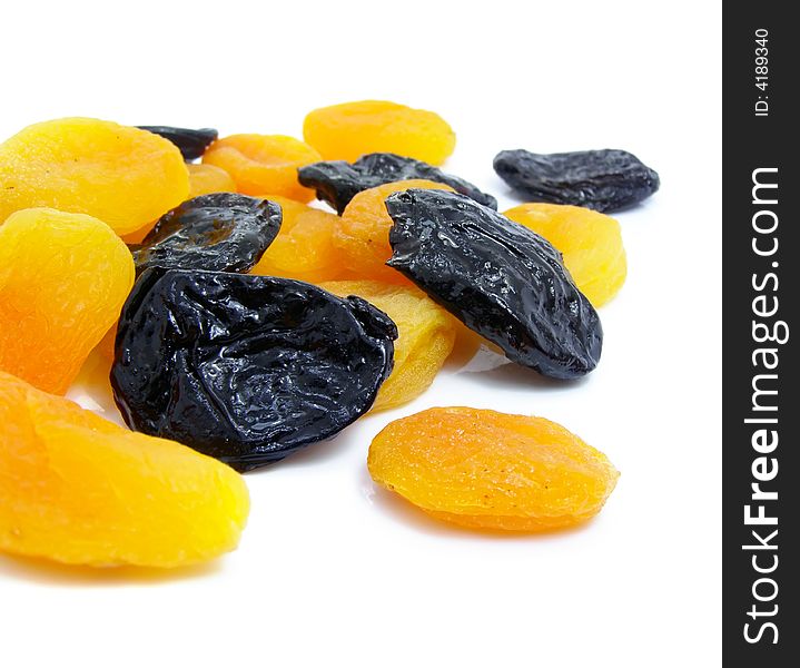 Dried apricot and black plum fruits isolated over white background