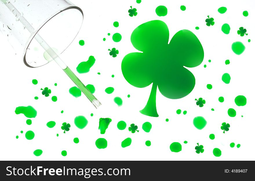 Spilled water glass with green drops shaped like four leaf clovers. Spilled water glass with green drops shaped like four leaf clovers