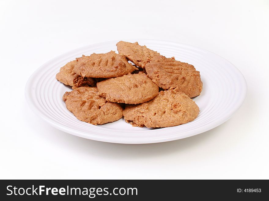 Peanut butter cookies on white plate on white background
