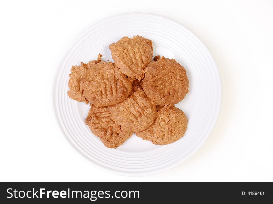 Peanut butter cookies on white plate on white background