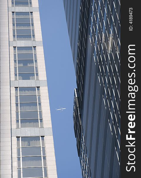 A plane is framed passing between the space in two skyscrapers in Hong Kong City. A plane is framed passing between the space in two skyscrapers in Hong Kong City