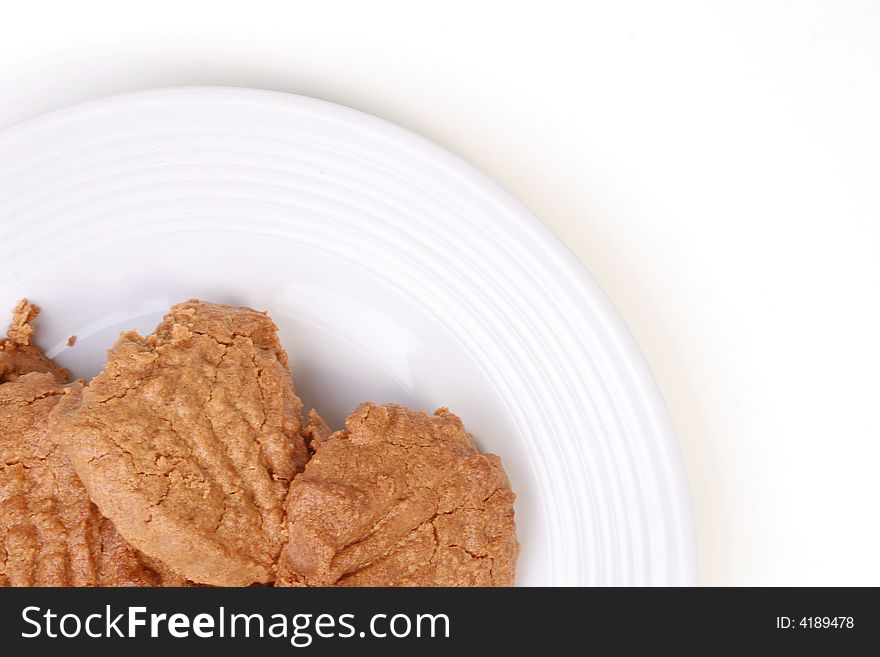 Peanut butter cookies on white plate on white background