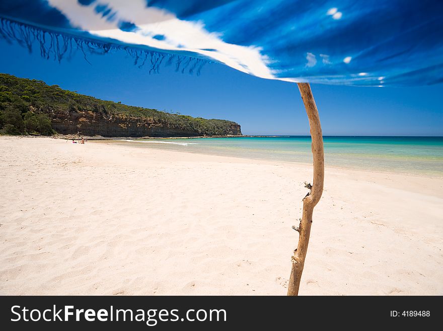 A view of a perfect beach scene from under the shade of a sarong. A view of a perfect beach scene from under the shade of a sarong