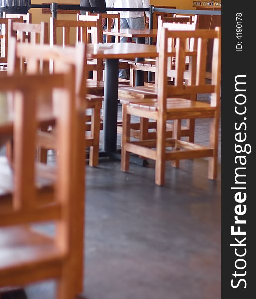 Chairs, tables, and people waiting in line inside restaurant. Chairs, tables, and people waiting in line inside restaurant