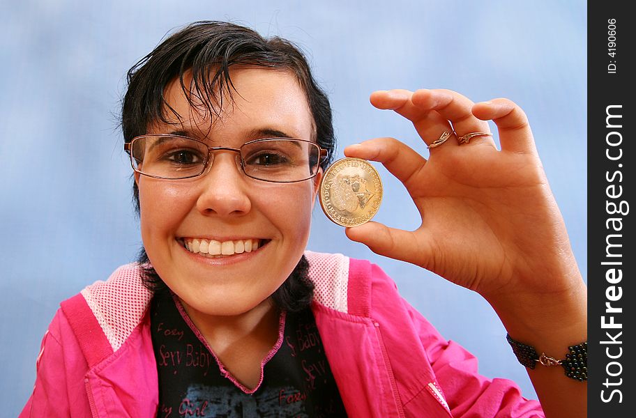 The joyful girl with a coin in a hand . The fish eye.