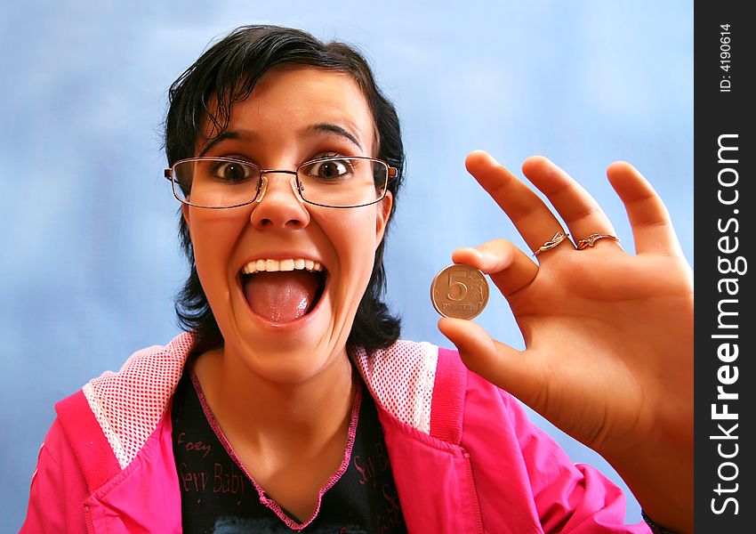 The joyful girl with a coin in a hand . The fish eye.