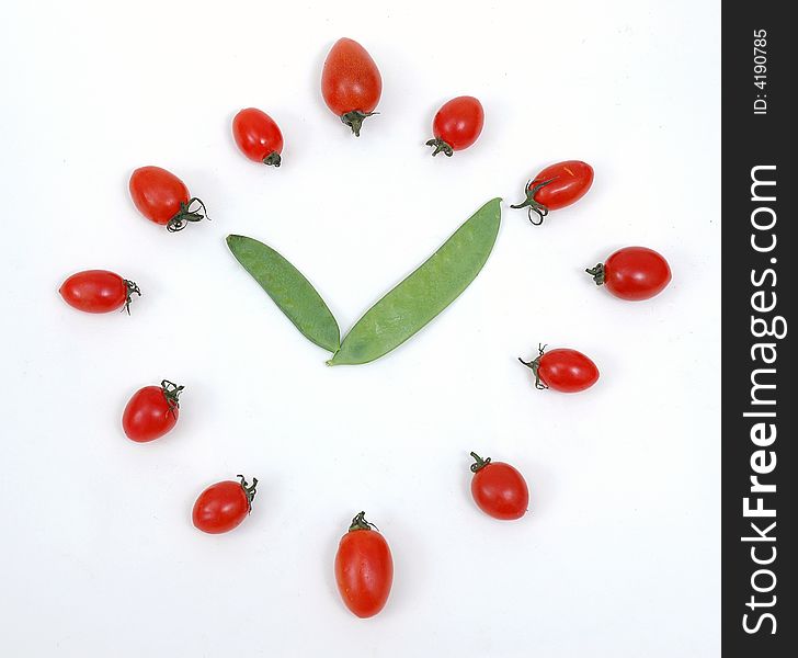 Vegetables in the white background of watches and clocks. Vegetables in the white background of watches and clocks