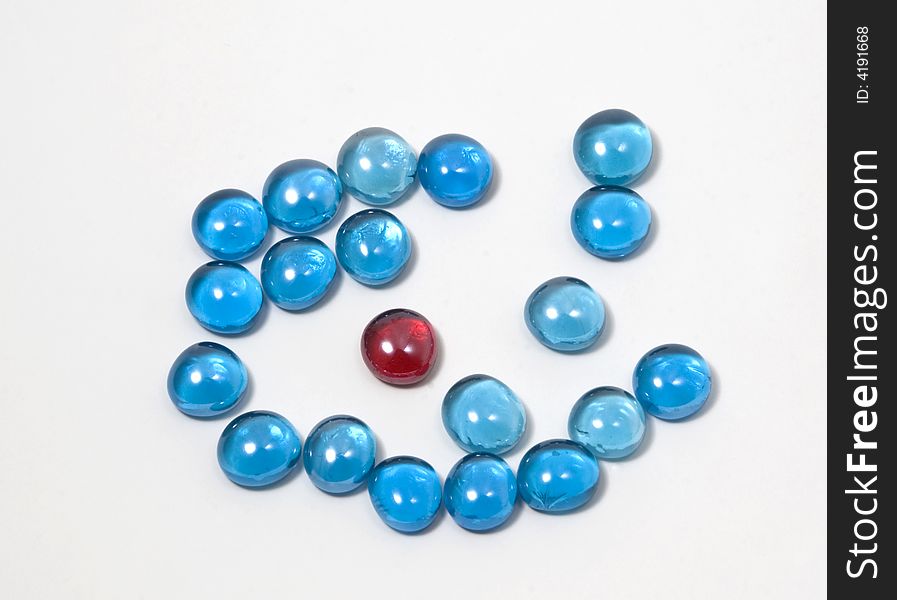 A red glass stone within blue ones for background decoration. A red glass stone within blue ones for background decoration