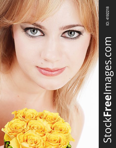 Close-up portrait pf pretty girl with huge grey eyes holding yellow roses in hands. Close-up portrait pf pretty girl with huge grey eyes holding yellow roses in hands