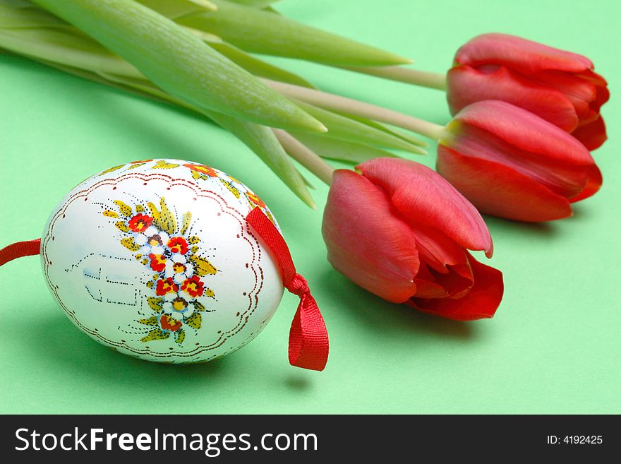 Painted Easter Egg And Red Tulips