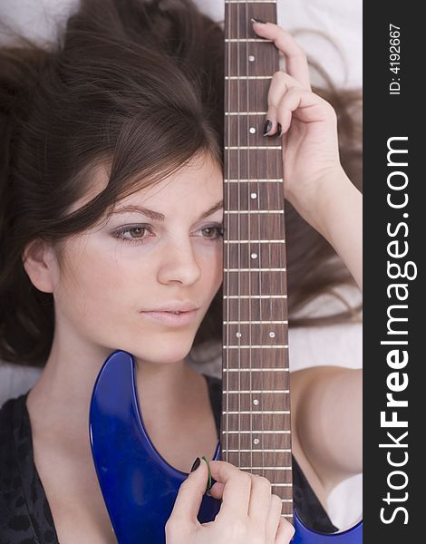 Portrait of a cute brunette with guitar. Portrait of a cute brunette with guitar