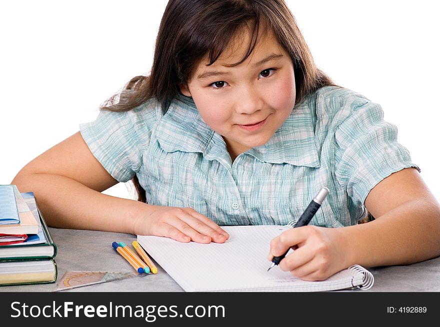 The girl does homework, isolated on a white background. The girl does homework, isolated on a white background.