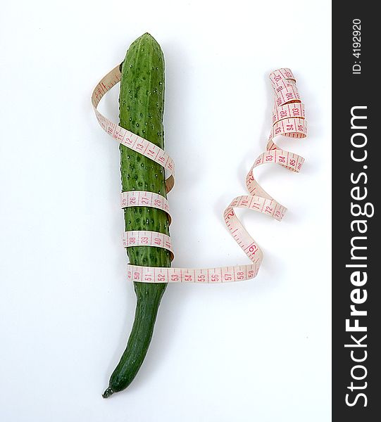 A  Cucumber   and a  tape on the white background. A  Cucumber   and a  tape on the white background
