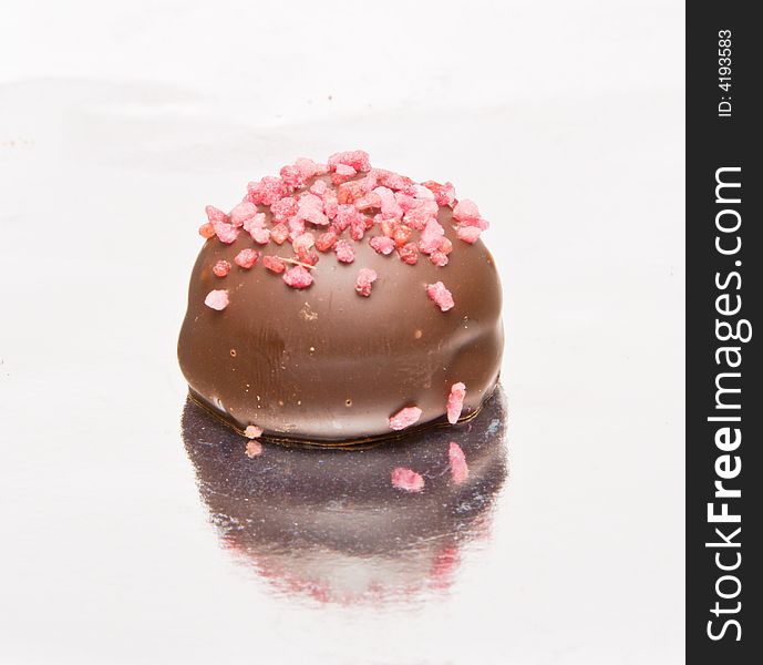 Famous Belgian chocolate candies. Close-up. Reflection in foil.