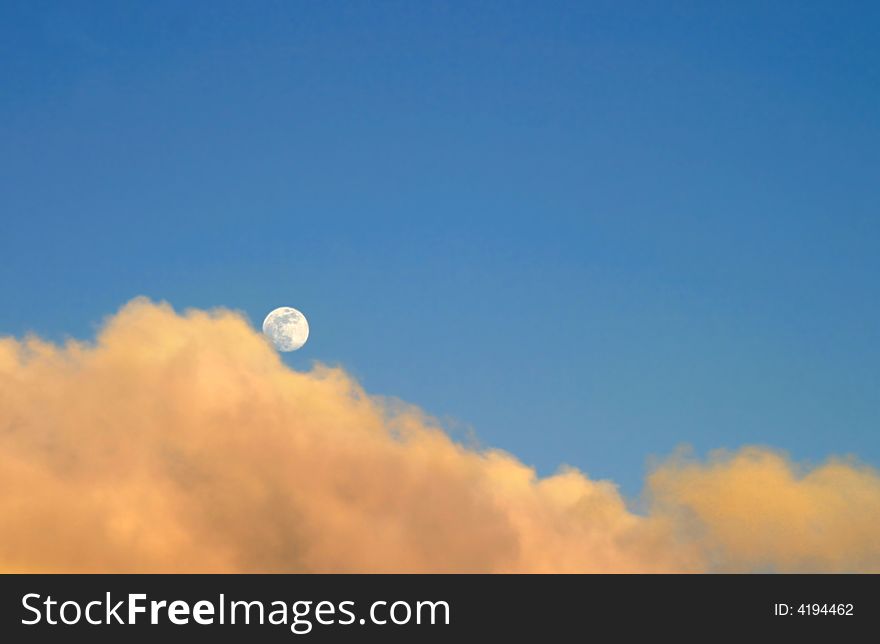 Moon at sunset with clouds