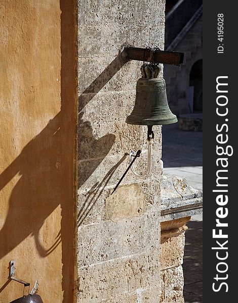 An old bell on a wall at a street of crete. An old bell on a wall at a street of crete