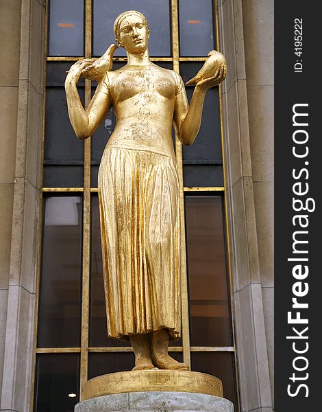 Golden statue of a woman next to eiffel tower in paris. Golden statue of a woman next to eiffel tower in paris