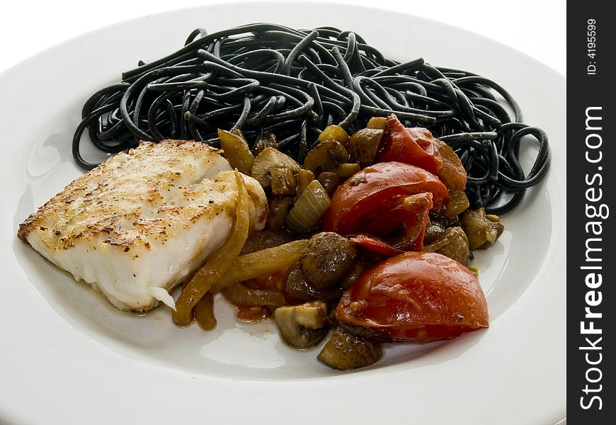 Fried fish fillet with black spaghetti, tomatoes and mushrooms