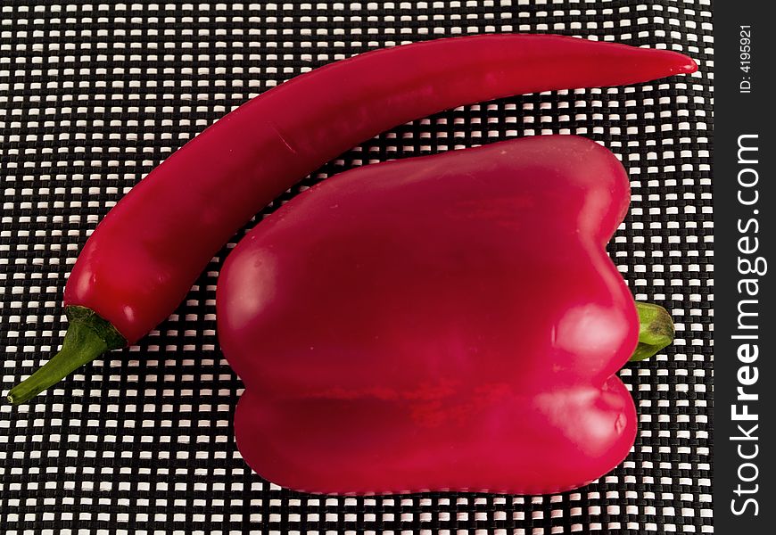 Two red peppers on black-white background