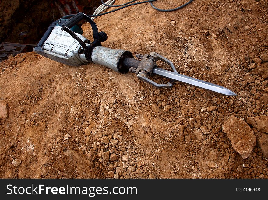 Grungy Pneumatic Hammer lying on ground