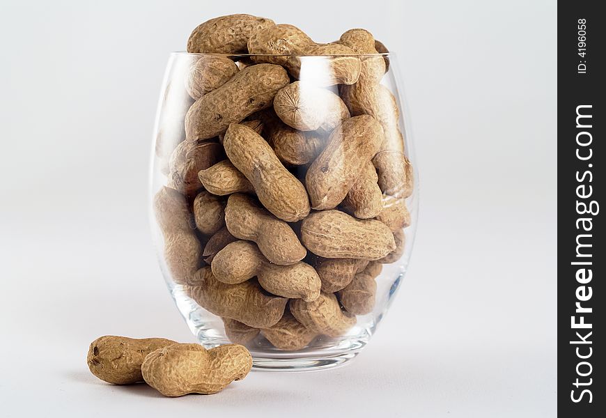 Light glass of peanuts isolated on white background. Light glass of peanuts isolated on white background