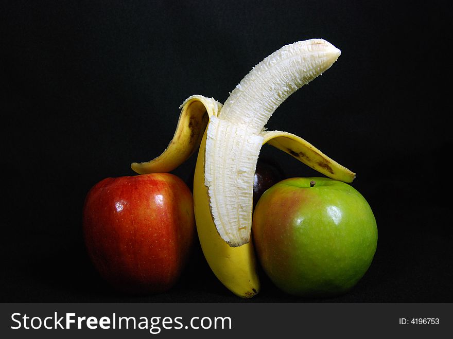 Ripe banana between two apples. Ripe banana between two apples.