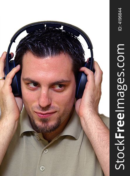 A man, wearing headphones, listening to some music, smiling. A man, wearing headphones, listening to some music, smiling