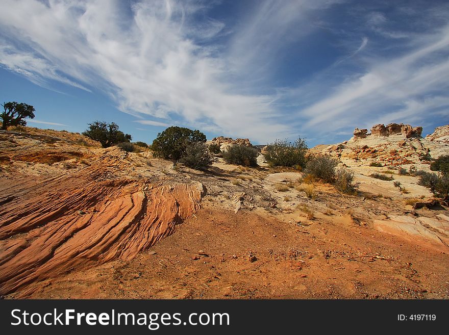View of the red rock formations in Canyonlands National Park with blue sky�s and clouds. View of the red rock formations in Canyonlands National Park with blue sky�s and clouds