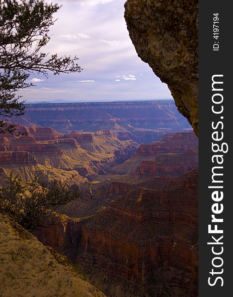 A view of Bright Angel Canyon framed by the rocks and trees at the North Rim of the Grand Canyon. A view of Bright Angel Canyon framed by the rocks and trees at the North Rim of the Grand Canyon.