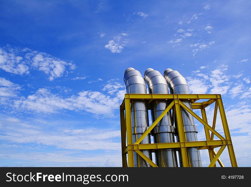 Exhausts under a blue sky with some clouds. Exhausts under a blue sky with some clouds