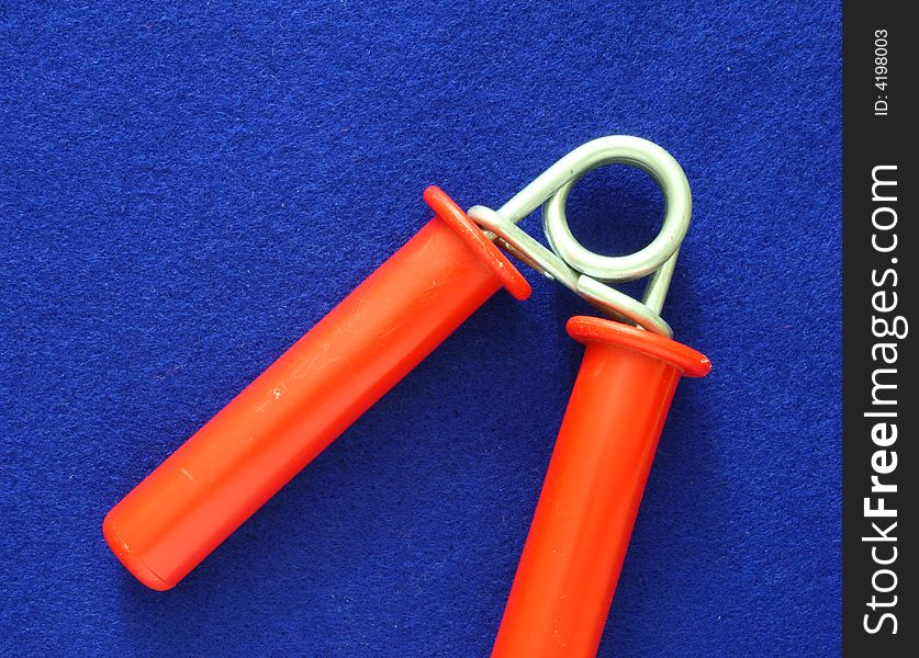 Red hand exerciser over a blue background