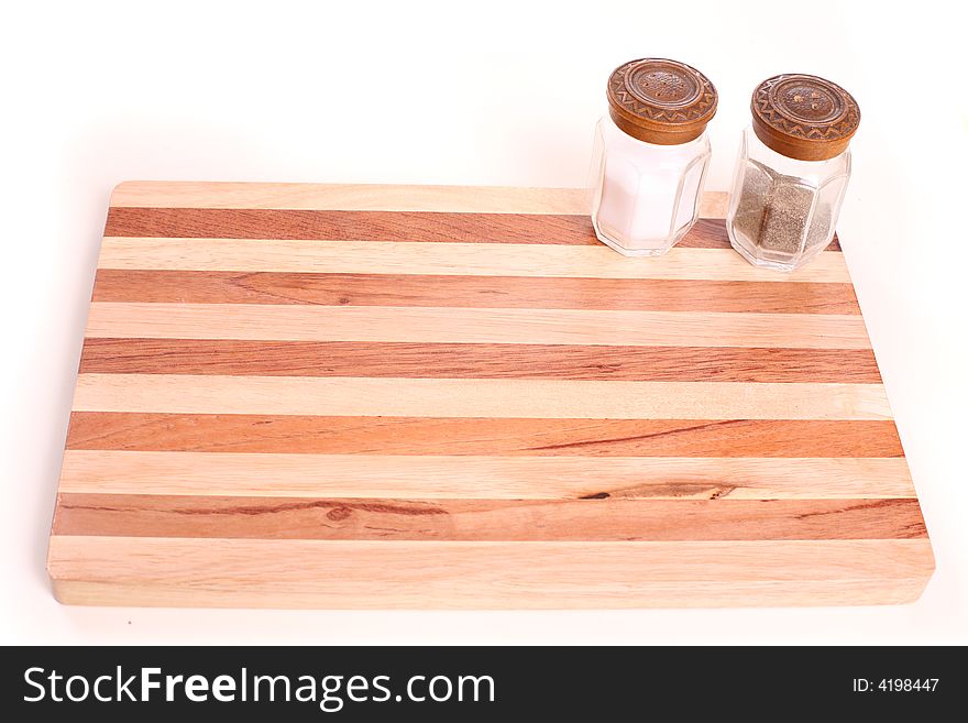 Kitchen board with pepper pot and salt - copy space