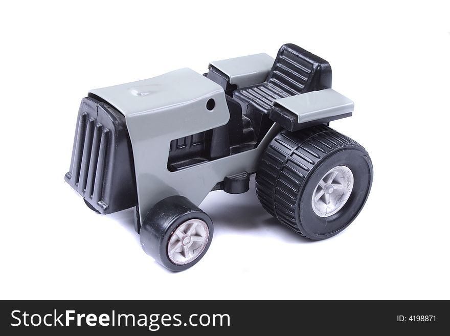 Grey tractor toy on the white background. Grey tractor toy on the white background