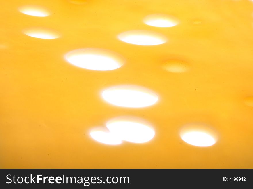 Fresh yellow cheese background (macro with many light)