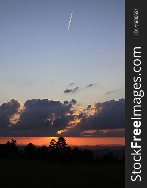 Sunset sky with plane that leaves a trail. Sunset sky with plane that leaves a trail