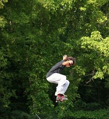 Skateboarder Jumping Near Trees Stock Image Skateboarder Jumping Near Trees Stock Image