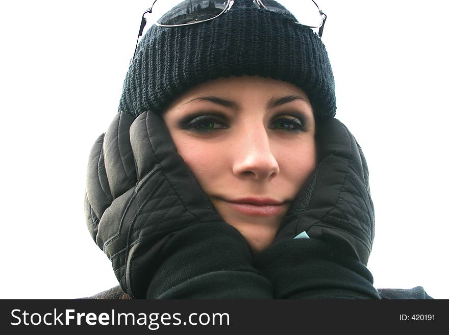 Young woman covers ears with gloved hands in the freezing winter weather. Young woman covers ears with gloved hands in the freezing winter weather.