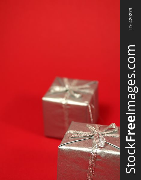 Silver gift boxes with red background