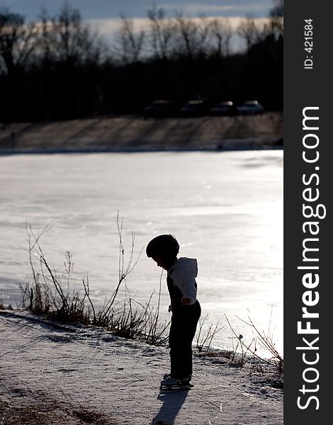 A young girl tests her ice skates for the first time. A young girl tests her ice skates for the first time.