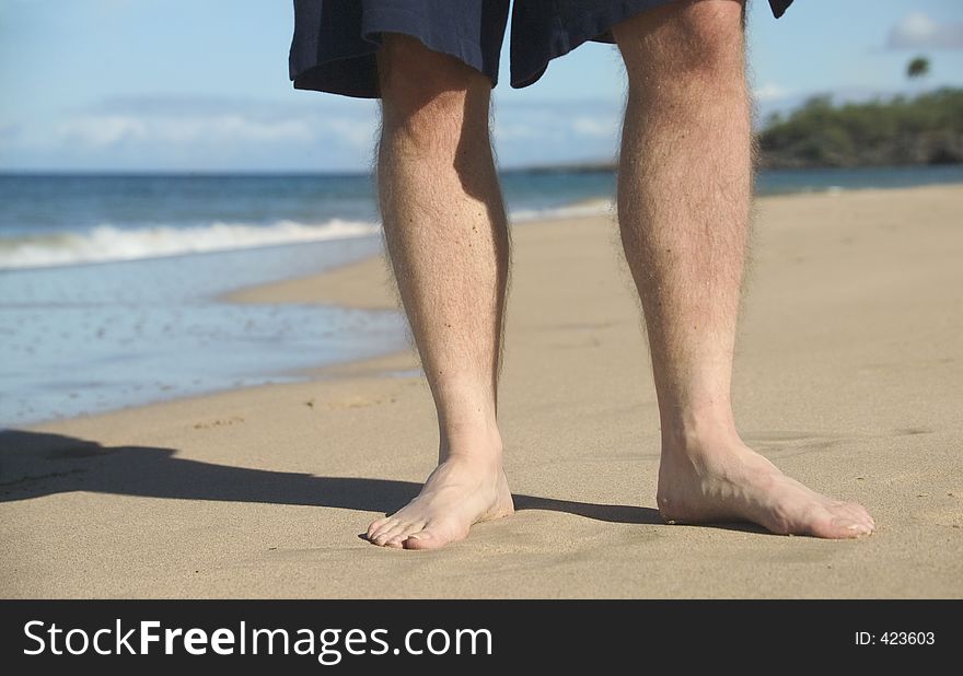 Man's feet on the beach. Man's feet on the beach