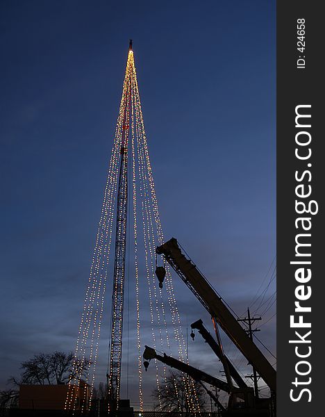 A crane supports a Christmas Tree. A crane supports a Christmas Tree.