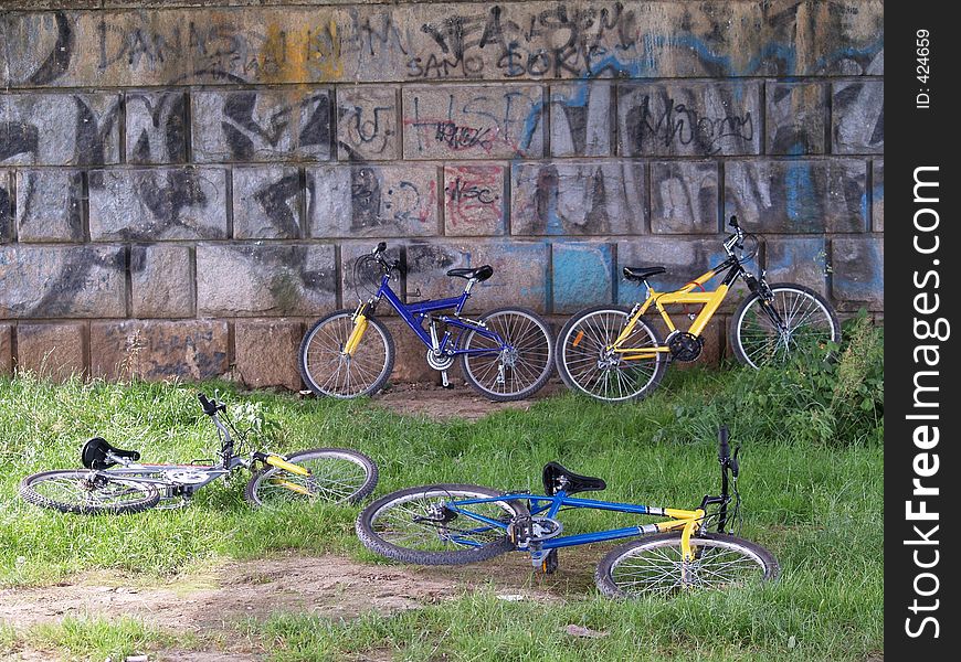 Bicycles leaned on the wall, children are playing somewhere