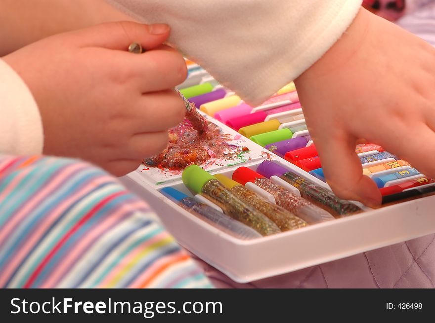 Child playing with coloured pencils and gels. Child playing with coloured pencils and gels