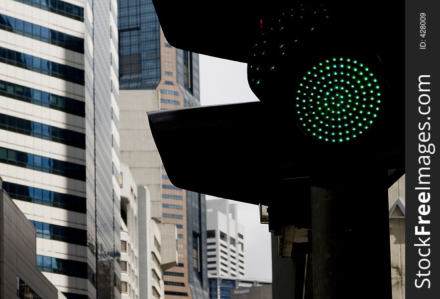 A traffic lights shows green in the business district of Singapore. A traffic lights shows green in the business district of Singapore