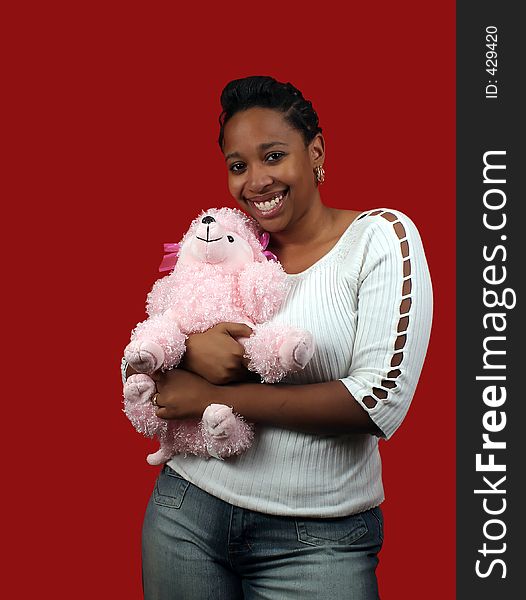 A beautiful young woman holding a pink poodle. A beautiful young woman holding a pink poodle.